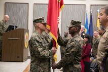 Brig. Gen. Bradford J. Gering, outgoing commander, receives the organizational colors from Sgt. Maj. Christopher G. Robinson before passing them to Lt. Gen. John E. Wissler, incoming commander of U.S. Marine Corps Forces Command and commanding general of Fleet Marine Force Atlantic, on Dec. 18, 2015, in Norfolk, Va.