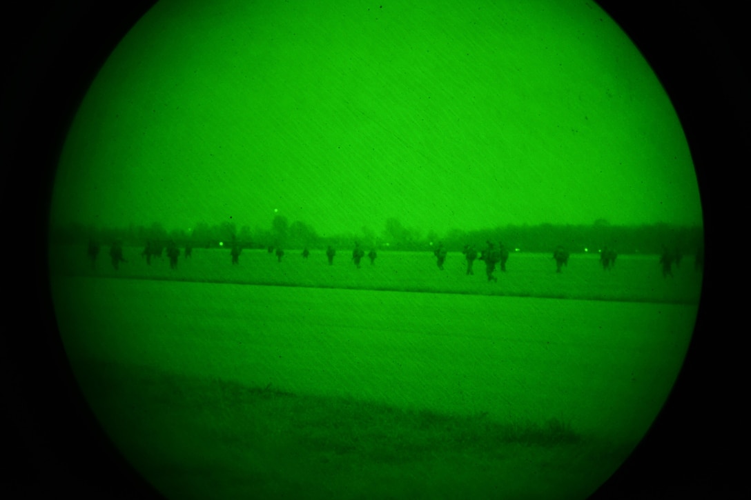As seen through a night-vision device, U.S. Army paratroopers participate in a follow-on mission after exiting U.S. Air Force C-130 Hercules aircraft during Exercise Rock Nemesis on Rivolto Air Base, Italy, Dec. 4, 2015. The paratroopers are assigned to the 2nd Battalion, 503rd Infantry Regiment, 173rd Airborne Brigade. The aircraft crew members are assigned to the 86th Air Wing. U.S. Army photo by Paolo Bovo