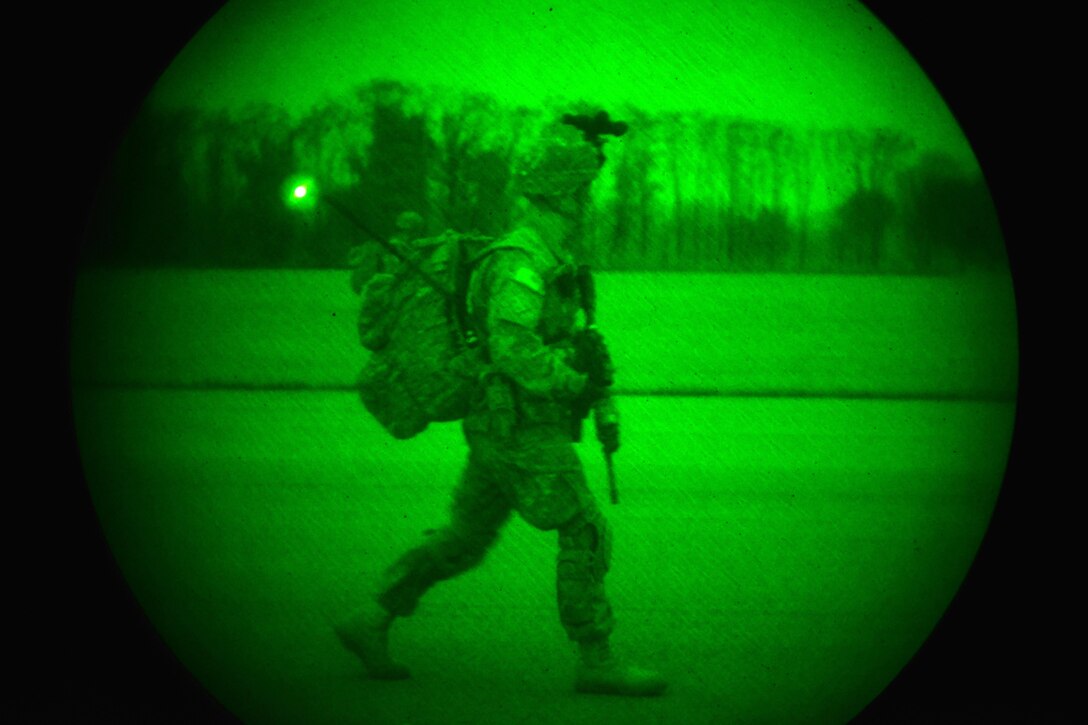 As seen through a night-vision device, a U.S. Army paratrooper visually scans the perimeter during a follow-on mission as part of Exercise Rock Nemesis on Rivolto Air Base, Italy, Dec. 4, 2015. U.S. Army photo by Paolo Bovo