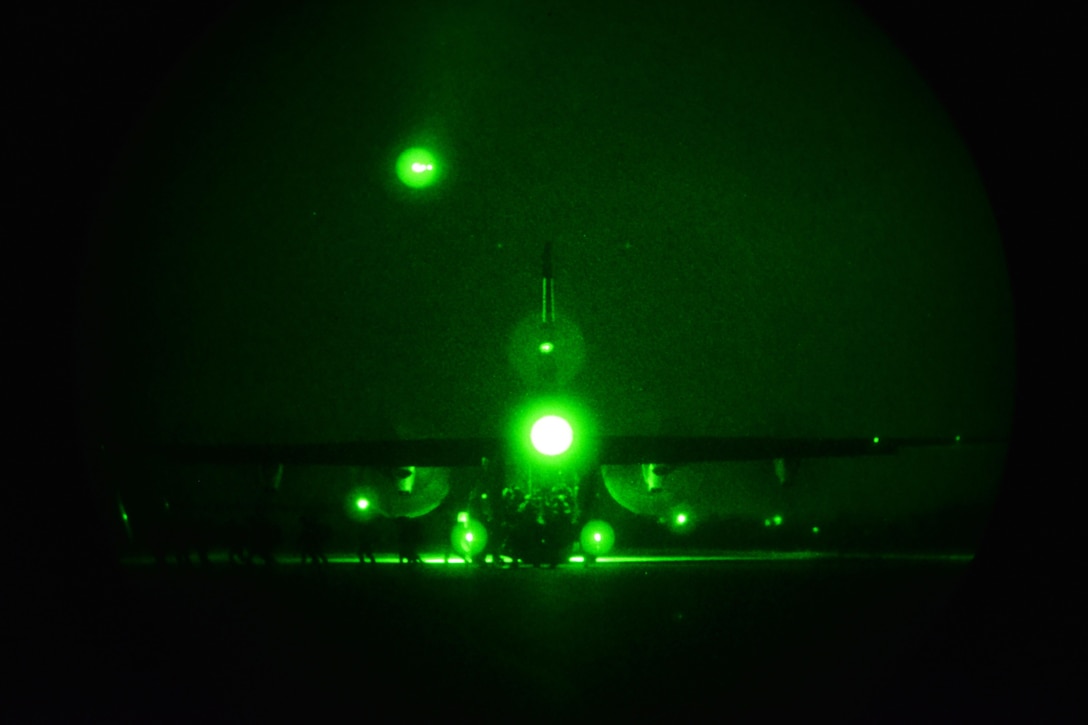 As seen through a night-vision device, U.S. Army paratroopers disembark from a U.S. Air Force C-130 Hercules aircraft during Exercise Rock Nemesis on Rivolto Air Base, Italy, Dec. 4, 2015. U.S. Army photo by Paolo Bovo