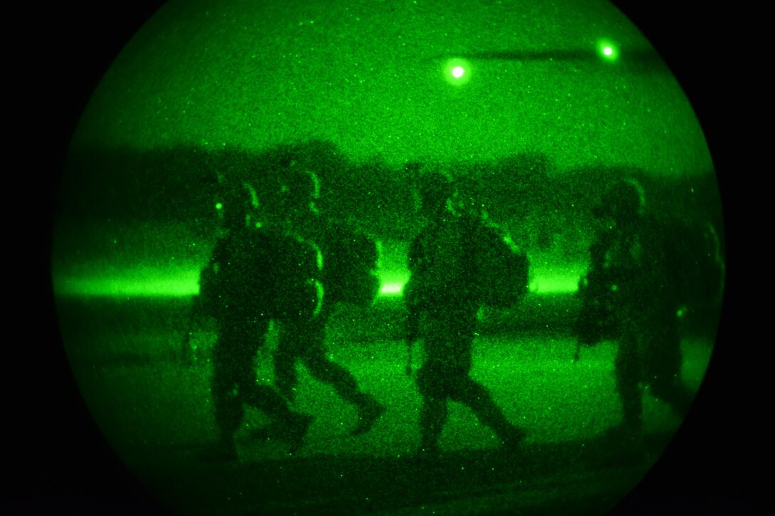 As seen through a night-vision device, U.S. Army paratroopers move out to their next objective during Exercise Rock Nemesis on Rivolto Air Base, Italy, Dec. 4, 2015. U.S. Army photo by Paolo Bovo