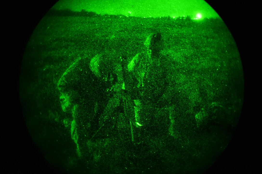 As seen through a night-vision device, U.S. Army paratroopers set up a mortar system during Exercise Rock Nemesis on Rivolto Air Base, Italy, Dec. 4, 2015. U.S. Army photo by Paolo Bovo
