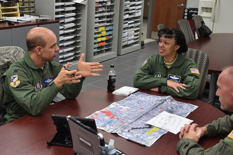Lt. Col.  Frank A. Galati, chief of standards and evaluation with the 757th Airlift Squadron, explains the details of a C-130 Spray Mission to Maj. Gen. Stayce Harris, 22nd Air Force Commander here Dec. 5, 2015. Col. Jeff Shaffer, aerial spray flight chief, listens in. Harris visited with Units of the 910th Airlift Wing during the December Unit Training weekend. (U.S. Air Force photo/Tech. Sgt. James Brock)