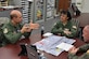 Lt. Col.  Frank A. Galati, chief of standards and evaluation with the 757th Airlift Squadron, explains the details of a C-130 Spray Mission to Maj. Gen. Stayce Harris, 22nd Air Force Commander here Dec. 5, 2015. Col. Jeff Shaffer, aerial spray flight chief, listens in. Harris visited with Units of the 910th Airlift Wing during the December Unit Training weekend. (U.S. Air Force photo/Tech. Sgt. James Brock)