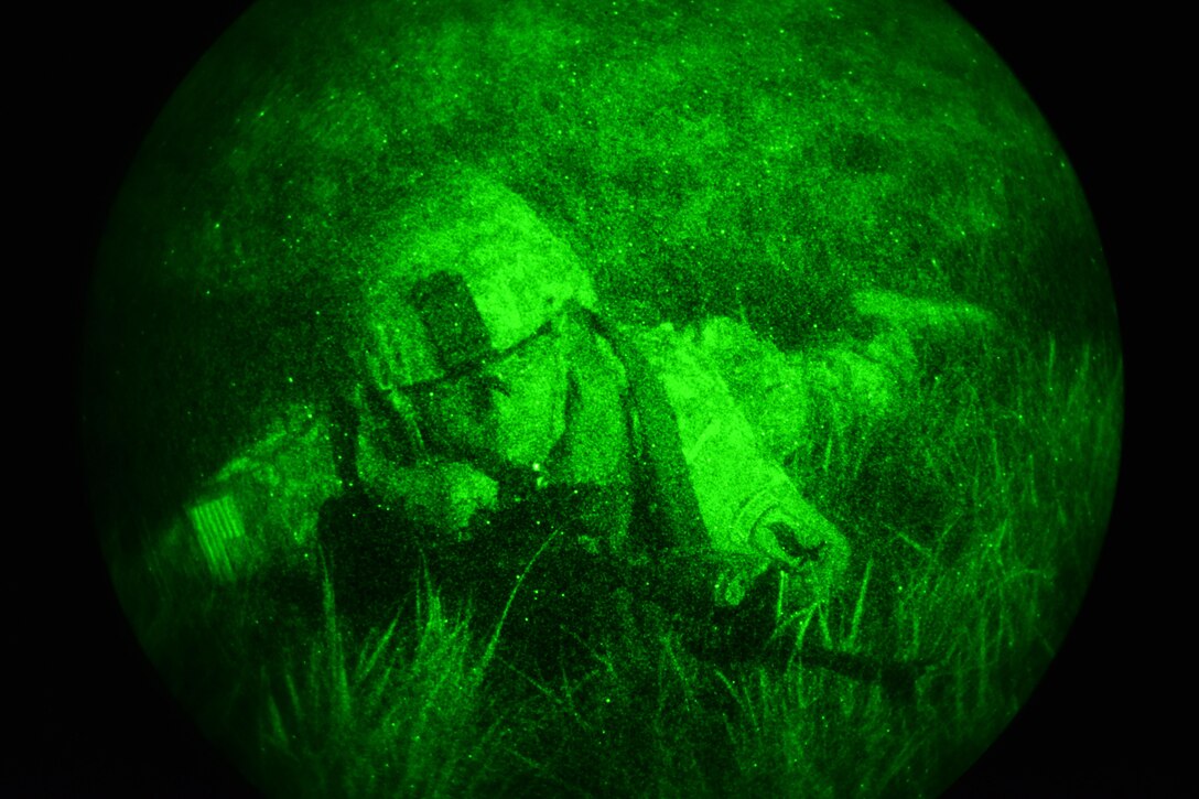 As seen through a night-vision device, a U.S. paratrooper provides security during Exercise Rock Nemesis on Rivolto Air Base, Italy, Dec. 4, 2015. U.S. Army photo by Paolo Bovo