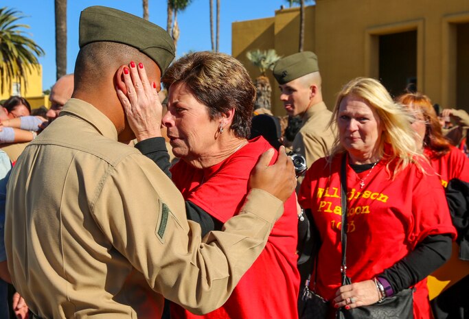 A Marine from Alpha Company, 1st Recruit Training Battalion, greets his loved one during liberty call at Marine Corps Recruit Depot San Diego, Dec. 17. This is the first time Marines have seen their families and friends since arriving at the depot 13 weeks ago. Today, all males recruited from west of the Mississippi are trained at MCRD San Diego. The depot is responsible for training more than 16,000 recruits annually. Alpha Company is scheduled to graduate Dec. 18.
