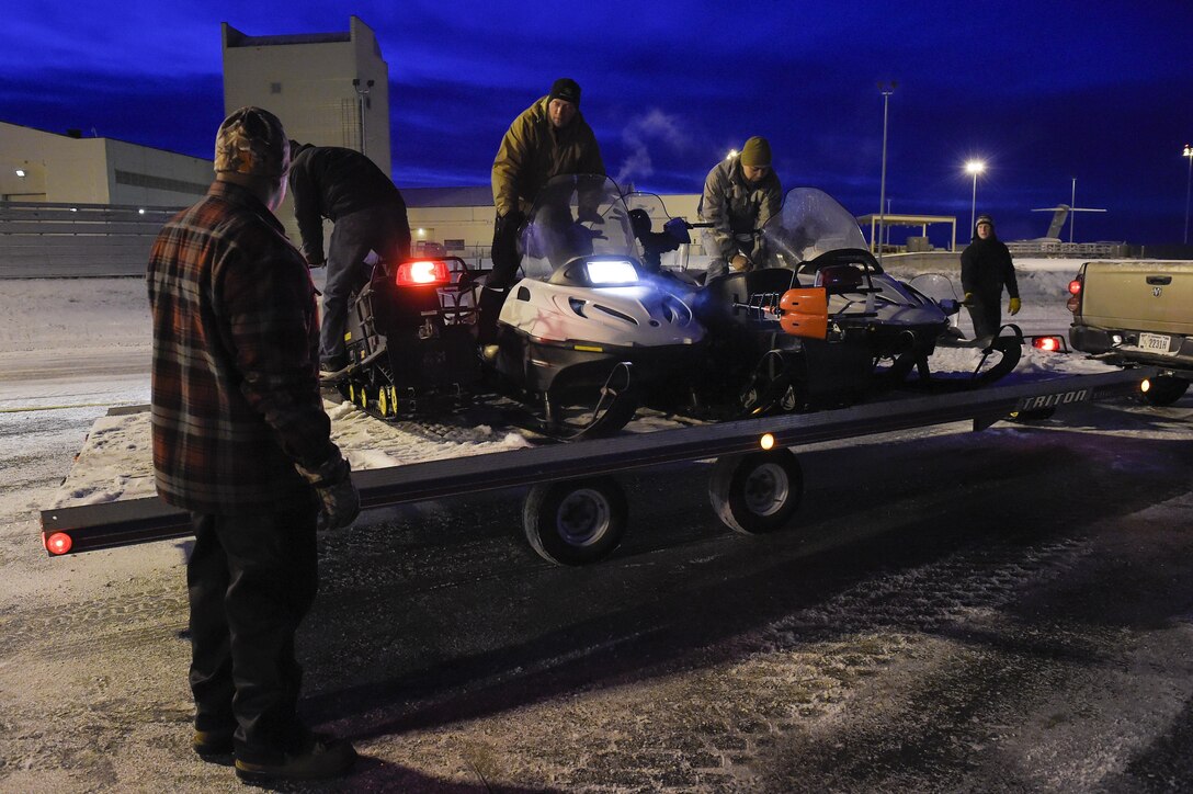 Marines load snow machines and gear onto a C-130H Hercules aircraft during Toys for Tots on Joint Base Elmendorf-Richardson, Alaska, Dec. 8, 2015. The Marines are assigned to Delta Company, 4th Law Enforcement Battalion. Toys for Tots is a U.S. Marine Corps Reserve program that delivers toys to children along with a message of hope during the holidays. U.S. Air Force photo by Alejandro Pena