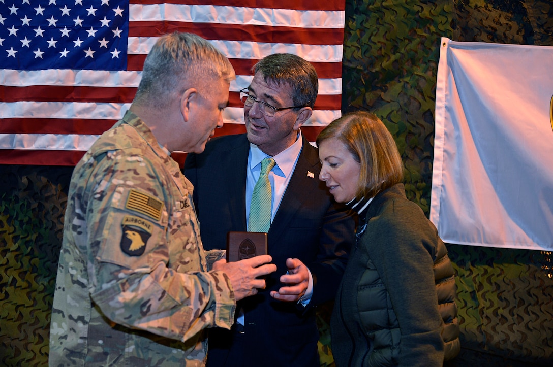 U.S. Army Gen. John F. Campbell presents a gift to U.S. Defense Secretary Ash Carter and his wife, Stephanie, during their visit on Forward Operating Base Fenty in Jalalabad, Afghanistan, Dec. 18, 2015. U.S. Air Force photo by Staff Sgt. Tony Coronado