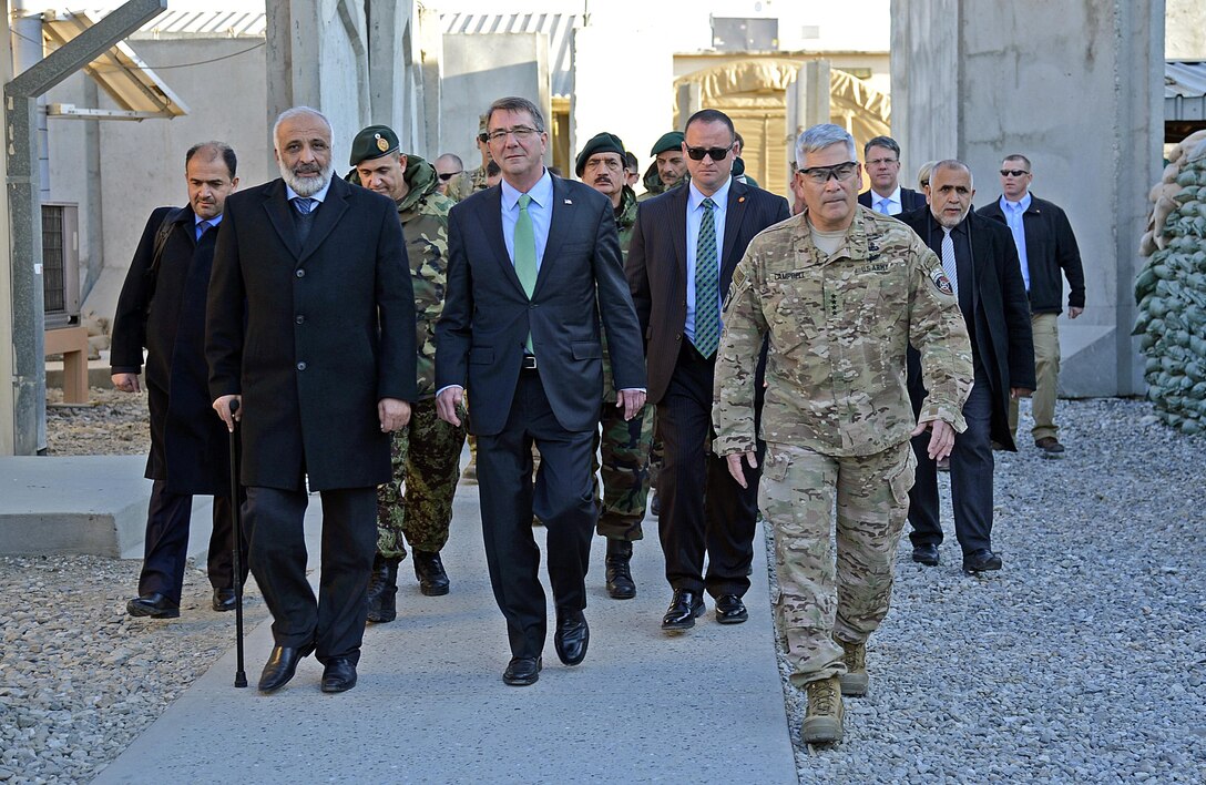 U.S. Defense Secretary Ash Carter, center, walks with Afghan Defense Minister Masoom Stanekzai, front left, and U.S. Army Gen. John F. Campbell, right, commander of NATO’s Resolute Support mission and U.S. Forces – Afghanistan, while visiting Forward Operating Base Fenty in Jalalabad, Afghanistan, Dec. 18, 2015. Carter is on a weeklong trip to the Middle East to meet with defense leaders and thank U.S. and coalition troops for their service and sacrifice, especially during the holiday season. U.S. Air Force photo by Staff Sgt. Tony Coronado