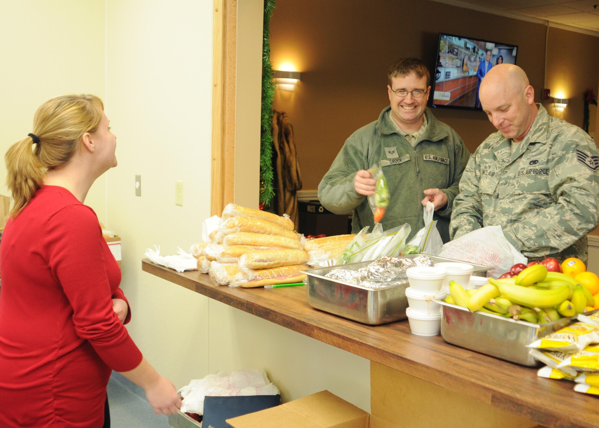 Senior Airman Adam Srock and Staff Sgt. Bryon Sinclair, both assigned to the 910th Maintenance Squadron, pick up their lunches at the express lunch line at the USO here, Dec. 5, 2015. The express line, intended to relieve congestion at the Community Activity Center during the lunch meal, serves Italian sub sandwiches and pepperoni rolls along with assorted snacks and drinks. (Air Force photo/Staff Sgt. Rachel Kocin)