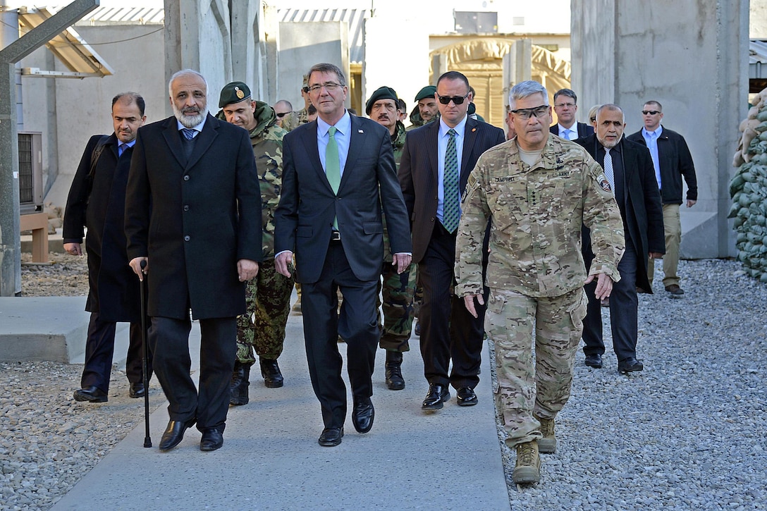 U.S. Defense Secretary Ash Carter, center, walks with Afghan Defense Minister Masoom Stanekzai, front left, and U.S. Army Gen. John F. Campbell, right, commander of NATO’s Resolute Support mission and U.S. Forces – Afghanistan, while visiting Forward Operating Base Fenty in Jalalabad, Afghanistan, Dec. 18, 2015. Carter is on a weeklong trip to the Middle East to meet with defense leaders and thank U.S. and coalition troops for their service and sacrifice, especially during the holiday season. U.S. Air Force photo by Staff Sgt. Tony Coronado