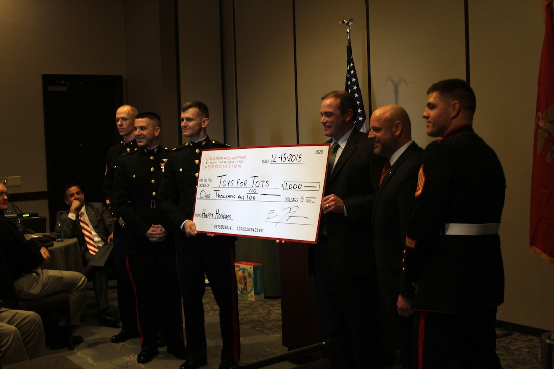 Marines and members of the Greater Richmond New Car Dealers Association pose with a check for $1,000 to be donated to Toys for Tots. The association and the Marines teamed up to donate toys to the less fortunate children in the greater Richmond area.