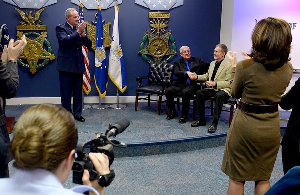 Air Force Chief of Staff Gen. Mark A. Welsh III congratulates retired Chief Master Sgt. Ronald W. Brodeur and Eric L. Roberts II after presenting them with the Silver Star during a ceremony at the Pentagon in Washington D.C., Dec. 17, 2015. Brodeur and Roberts received their medals for their gallant action in Vietnam. (U.S. Air Force photo/Scott M. Ash)
