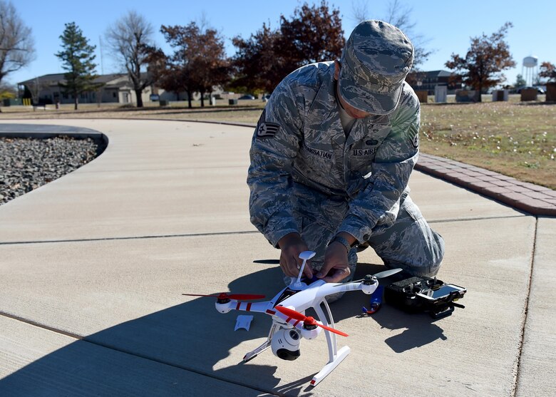 U.S. Air Force Staff Sgt. Anont Koonkongsatian, 97th Air Mobility Wing Safety Office safety technician and drone enthusiast, prepares to fly his drone to demonstrate how he uses it for official purposes at Wings of Freedom Park, Dec. 15, 2015. With the increase of drones’ popularity in the last few years, laws restricting the use of drones within 5 miles of an airbase have been made but some exceptions are made for official tasks such as checking roofs and showing cleared roadways on base. (U.S. Air Force photo by Airman 1st Class Kirby Turbak/Released)