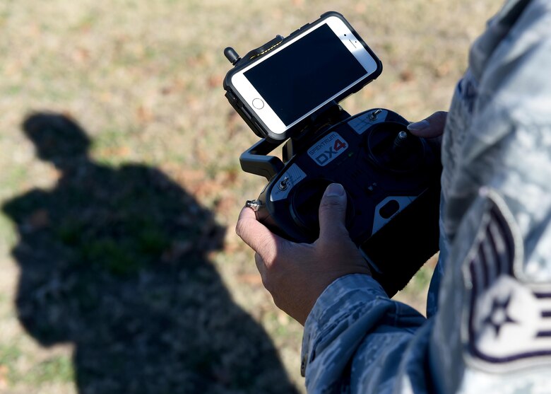 U.S. Air Force Staff Sgt. Anont Koonkongsatian, 97th Air Mobility Wing Safety Office safety technician and drone enthusiast, operates a drone to demonstrate how it is used for official purposes at Wings of Freedom Park, Dec. 15, 2015. With the increase of drones’ popularity in the last few years, laws restricting the use of drones within 5 miles of an airbase have been made but some exceptions are made for official tasks such as checking roofs and showing cleared roadways on base. (U.S. Air Force photo by Airman 1st Class Kirby Turbak/Released)