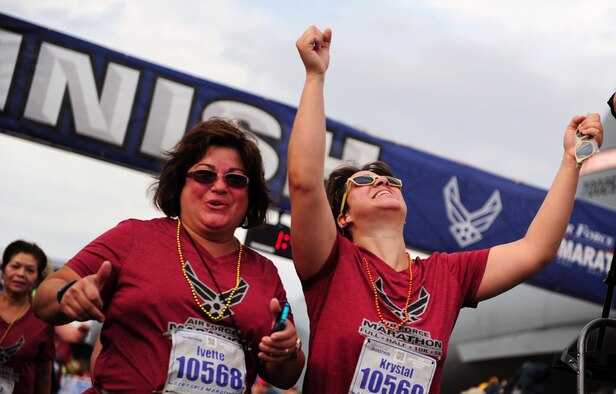 Runners celebrate at the finish line during the 19th Annual U.S. Air Force Marathon Saturday, Sept. 19, 2014, on Wright-Patterson Air Force Base, Ohio. The marathon maxed out its entries with 15,000 competitors racing in the 10-kilometer, half marathon, and full marathon; along with more than 2,000 service members running in deployed locations around the world. The first Air Force Marathon took place in 1997 and had 2,600 racers. (U.S. Air Force photo by Tech. Sgt. Raymond Hoy)