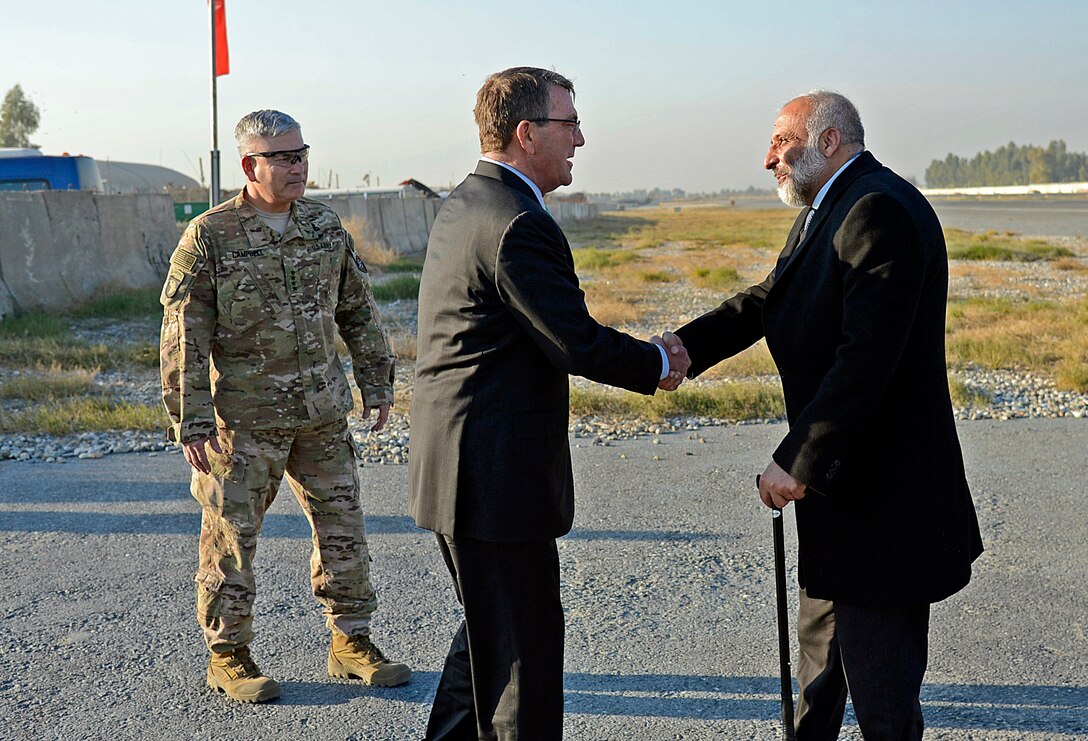 U.S. Defense Secretary Ash Carter exchanges greetings with Afghan Defense Minister Masoom Stanekzai on Forward Operating Base Fenty in Jalalabad, Afghanistan, Dec. 18, 2015. U.S. Air Force photo by Staff Sgt. Tony Coronado