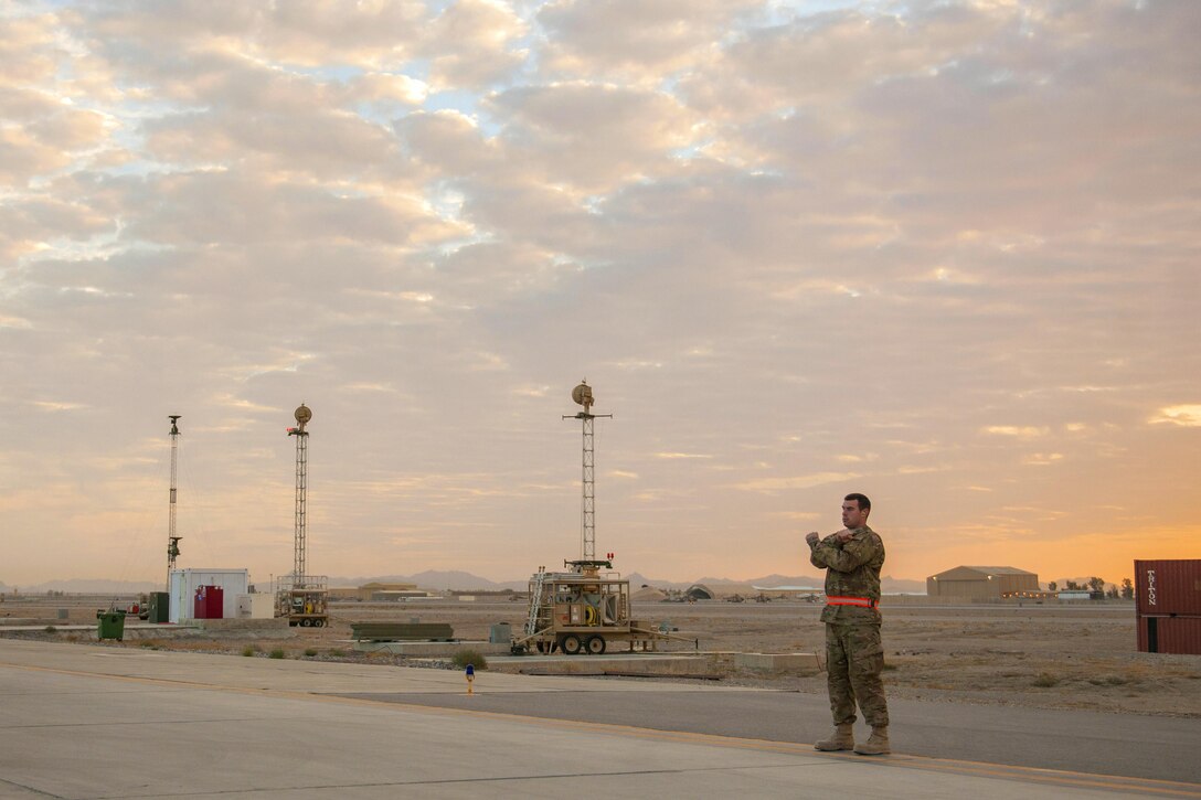 U.S. Air Force Senior Airman Christopher marshals an MQ-9 Reaper for end-of-runway checks on Kandahar Airfield, Afghanistan, Dec. 6, 2015. Christopher is a weapons load crew member assigned to the 62nd Expeditionary Reconnaissance Squadron. U.S. Air Force photo by Tech. Sgt. Robert Cloys