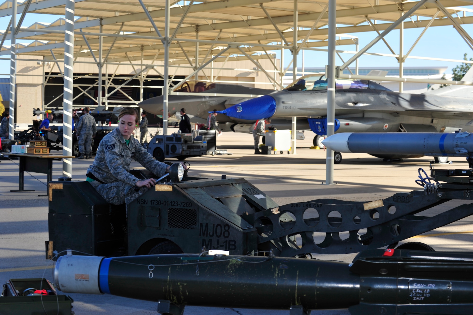 Staff Sgt. Cally Hatrick, 310st Aircraft Maintenance Unit weapons load crew member, prepares to load an F-16 Fighting Falcon during the 4th quarter weapon's loading competition Dec. 18 at Luke Air Force Base, Ariz. This quarter featured the first time the F-35 Lightning ll was used in the competition against the F-16 at Luke. Three man crews from the 61st AMU, 309th AMU, 310th AMU, and the 425th AMU went head to head to earn this quarters win. (U.S. Air Force photo by Senior Airman Grace Lee)