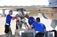 309th Aircraft Maintenance Unit weapons load crew members, prepare to load an F-16 Fighting Falcon during the 4th quarter weapon's loading competition Dec. 18 at Luke Air Force Base, Ariz. This quarter featured the first time the F-35 Lightning ll was used in the competition against the F-16 at Luke. Three man crews from the 61st AMU, 309th AMU, 310th AMU, and the 425th AMU went head to head to earn this quarters win. (U.S. Air Force photo by Senior Airman Grace Lee)
