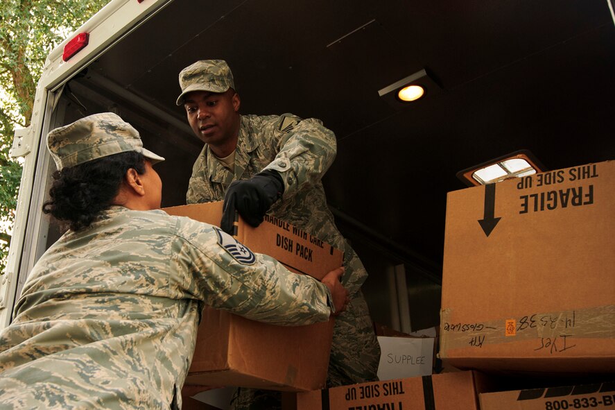 Airmen from the 446th Airlift Wing unload food boxes at the 446th AW Annex here, Dec. 15, 2015. Food baskets for the December holidays are donated by the Central Pierce County Fire Department, Tacoma, Washington. The department donated 50 of its 450 dinner boxes to the wing Care and Share program, run by the 446th Force Support Squadron, Airman & Family Readiness Center here. Food drives are the cornerstone of Care and Share because they support Reserve families, who endure financial stress during the holiday season, said Mr. Carl Supplee, A&FRC director.