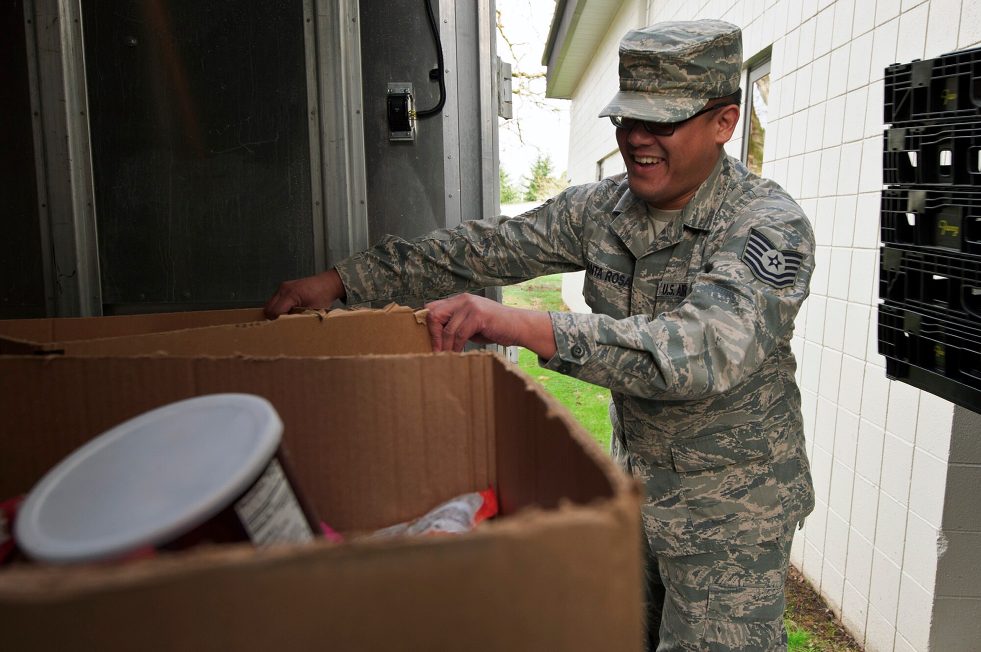 A 446th Airlift Wing Citizen Airman helps unload food boxes at the wing annex here, Dec. 15, 2015. Food baskets for the December holidays are donated by the Central Pierce County Fire Department, Tacoma, Washington. The department donated 50 of its 450 dinner boxes to the wing Care and Share program, run by the 446th Force Support Squadron, Airman & Family Readiness Center here. Food drives are the cornerstone of Care and Share because they support Reserve families, who endure financial stress during the holiday season, said Mr. Carl Supplee, A&FRC director.