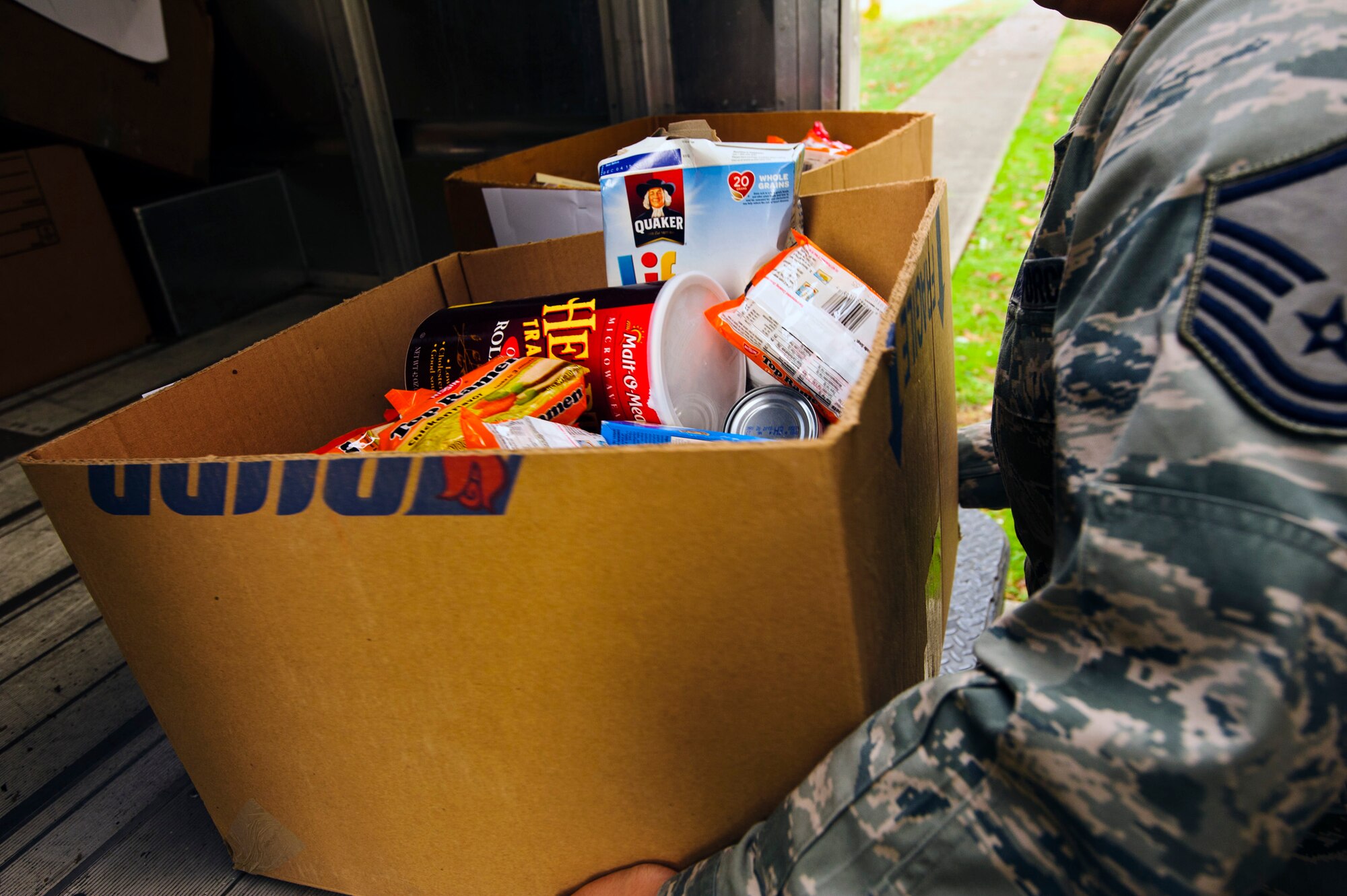 A 446th Airlift Wing Reservist unloads a food box at the wing annex here, Dec. 15, 2015. Food baskets for the December holidays are donated by the Central Pierce County Fire Department, Tacoma, Washington. The department donated 50 of its 450 dinner boxes to the wing Care and Share program, run by the 446th Force Support Squadron, Airman & Family Readiness Center here. Food drives are the cornerstone of Care and Share because they support Reserve families, who endure financial stress during the holiday season, said Mr. Carl Supplee, A&FRC director.