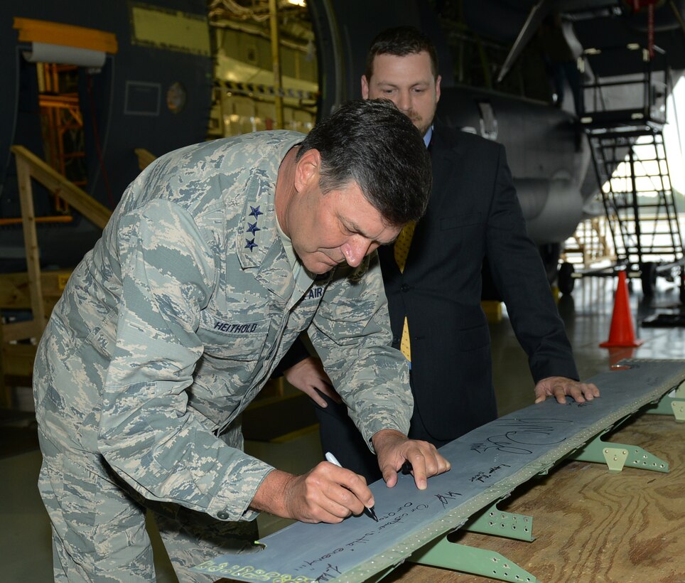 Lt. Gen. Brad Heithold, commander of Air Force Special Operations Command, signs an AC-130J part at the Lockheed Martin facility in Crestview, Fla., Dec. 16, 2015. Lockheed Martin is performing a series of modifications to new MC-130Js, which converts the aircraft to the AC gunship model. (U.S. Air Force photo/Staff Sgt. Melanie Holochwost)