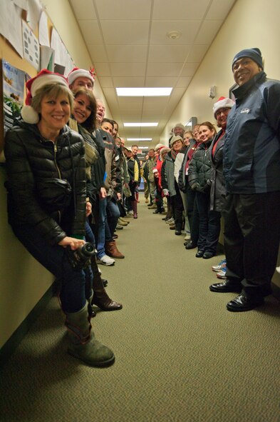 Local community and military leaders take a breather after unloading boxes of ham at the 446th Airlift Wing Annex here, Dec. 17, 2015. Operation Ham Grenade, which local community leaders, organizations, and individuals give hams to Airmen for their holiday dinners, donated 44 hams to support the 446th AW Care and Share program. Care and Share, managed by the 446th Force Support Squadron, Airman & Family Readiness Center here, helps feed Reserve families, who endure financial stress during the holiday season.