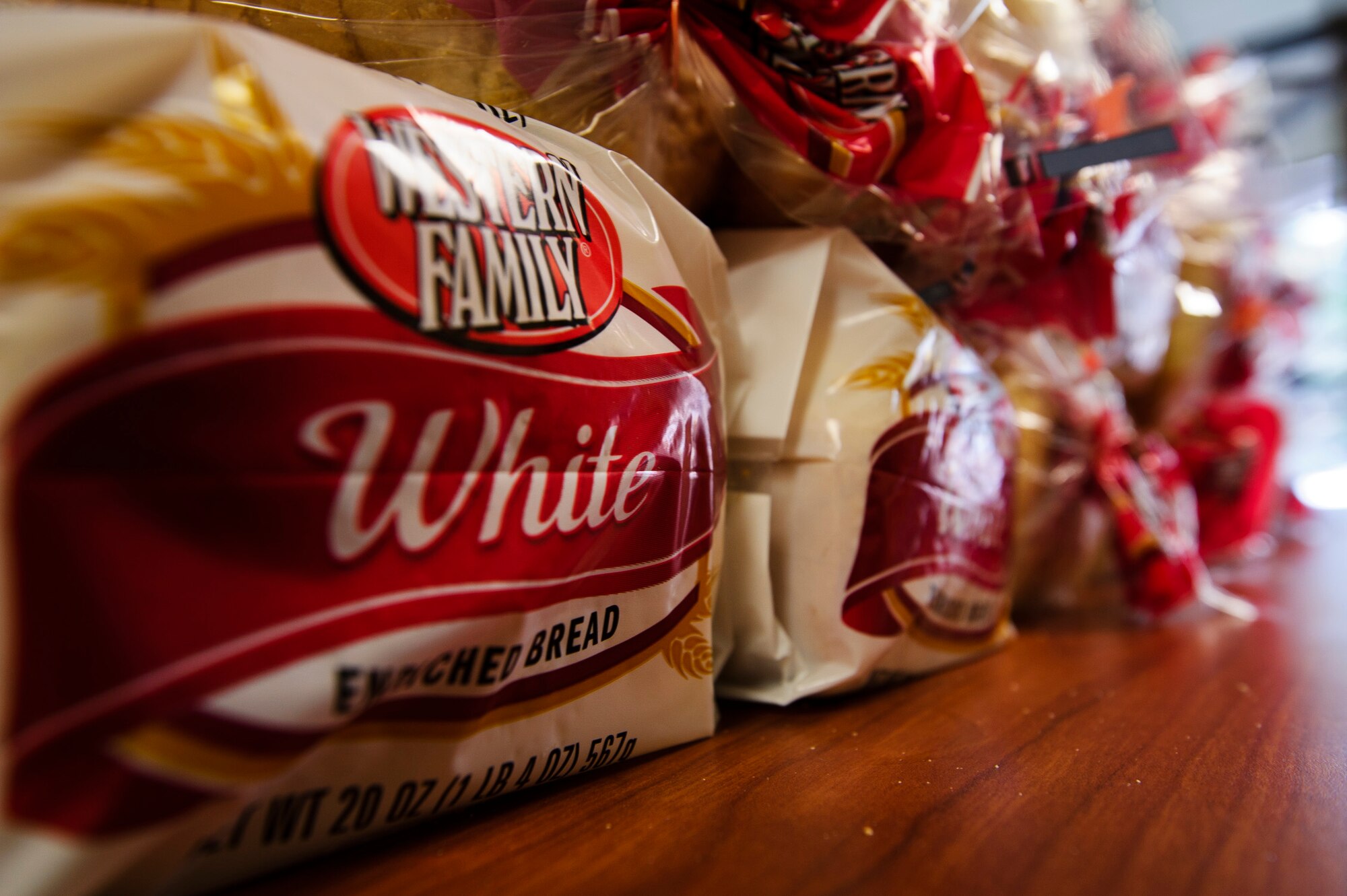 Stacks of bread wait to be taken in by various Reserve family homes, Dec. 15, 2015. Food baskets for the December holidays are donated by the Central Pierce County Fire Department, Tacoma, Washington. The department donated 50 of its 450 dinner boxes to the 446th Airlift Wing Care and Share program, run by the 446th Force Support Squadron, Airman & Family Readiness Office here. Food drives are the cornerstone of Care and Share because they support Reserve families who endure financial stress during the holiday season. 
