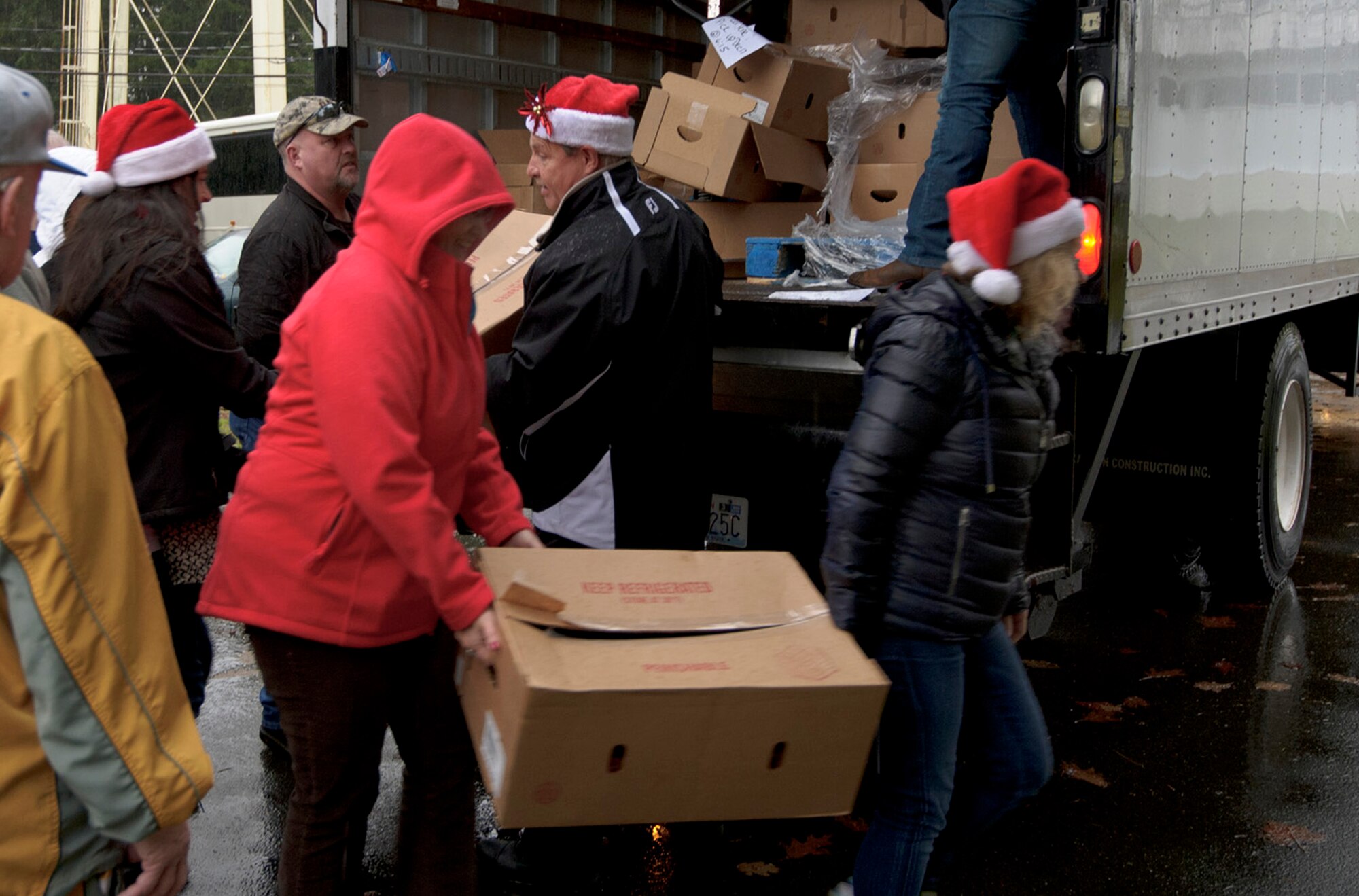 Local community leaders help unload boxes of ham at the 446th Airlift Wing Annex here, Dec. 17, 2015 as part of Operation Ham Grenade, which local community leaders, organizations, and individuals donate hams to Airmen for their holiday dinners. A total of 44 hams were donated to the 446th AW Care and Share program, which supports Reserve families, who endure financial stress during the holiday season.