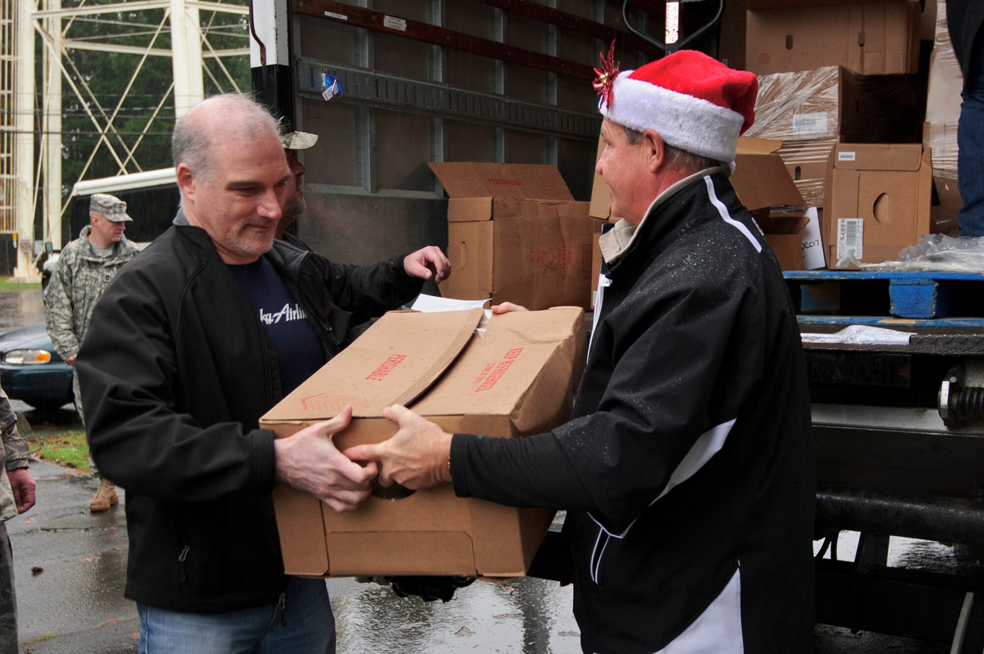 Local community leaders help unload boxes of ham at the 446th Airlift Wing Annex here, Dec. 17, 2015 as part of Operation Ham Grenade, which local community leaders, organizations, and individuals donate hams to Airmen for their holiday dinners. A total of 44 hams were donated to the 446th AW Care and Share program, which supports Reserve families, who endure financial stress during the holiday season.