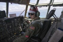 First Lt. Sydney Croxton, 36th Airlift Squadron C-130 pilot, flies over Republic of Palau, Dec. 11, 2015, during Operation Christmas Drop. This year marks the 64th year of Operation Christmas Drop, which began in 1952, and is the first trilateral execution of the event with support from Japan Air Self-Defense Force and Royal Australian Air Force C-130s. (U.S. Air Force photo by Osakabe Yasuo/Released)