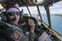 First Lt. Sydney Croxton, 36th Airlift Squadron C-130 pilot, flies over Republic of Palau, Dec. 11, 2015, during Operation Christmas Drop. This year marks the 64th year of Operation Christmas Drop, which began in 1952, and is the first trilateral execution of the event with support from Japan Air Self-Defense Force and Royal Australian Air Force C-130s. (U.S. Air Force photo by Osakabe Yasuo/Released)