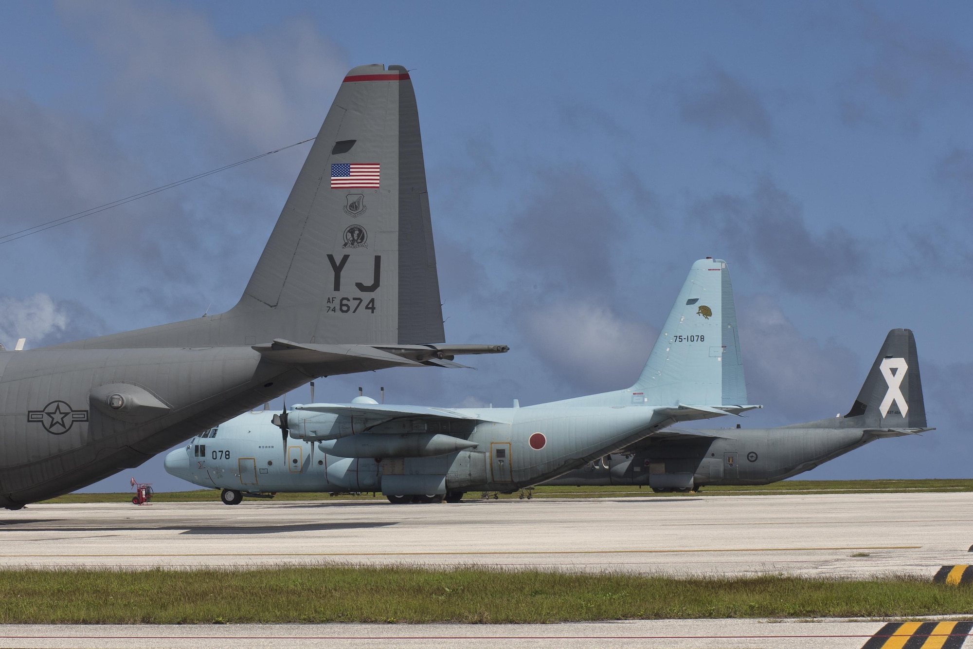 C-130s from the U.S. Air Force, Japan Air Self-Defense Force and Royal Australian Air Force park on the ramp at Andersen Air Force Base, Dec. 6, 2015 in preparation for Operation Christmas Drop. This year marks the 64th year of Operation Christmas Drop and the first trilateral execution of Department of Defense's longest running humanitarian airdrop mission. (U.S. Air Force photo by Osakabe Yasuo/Released)