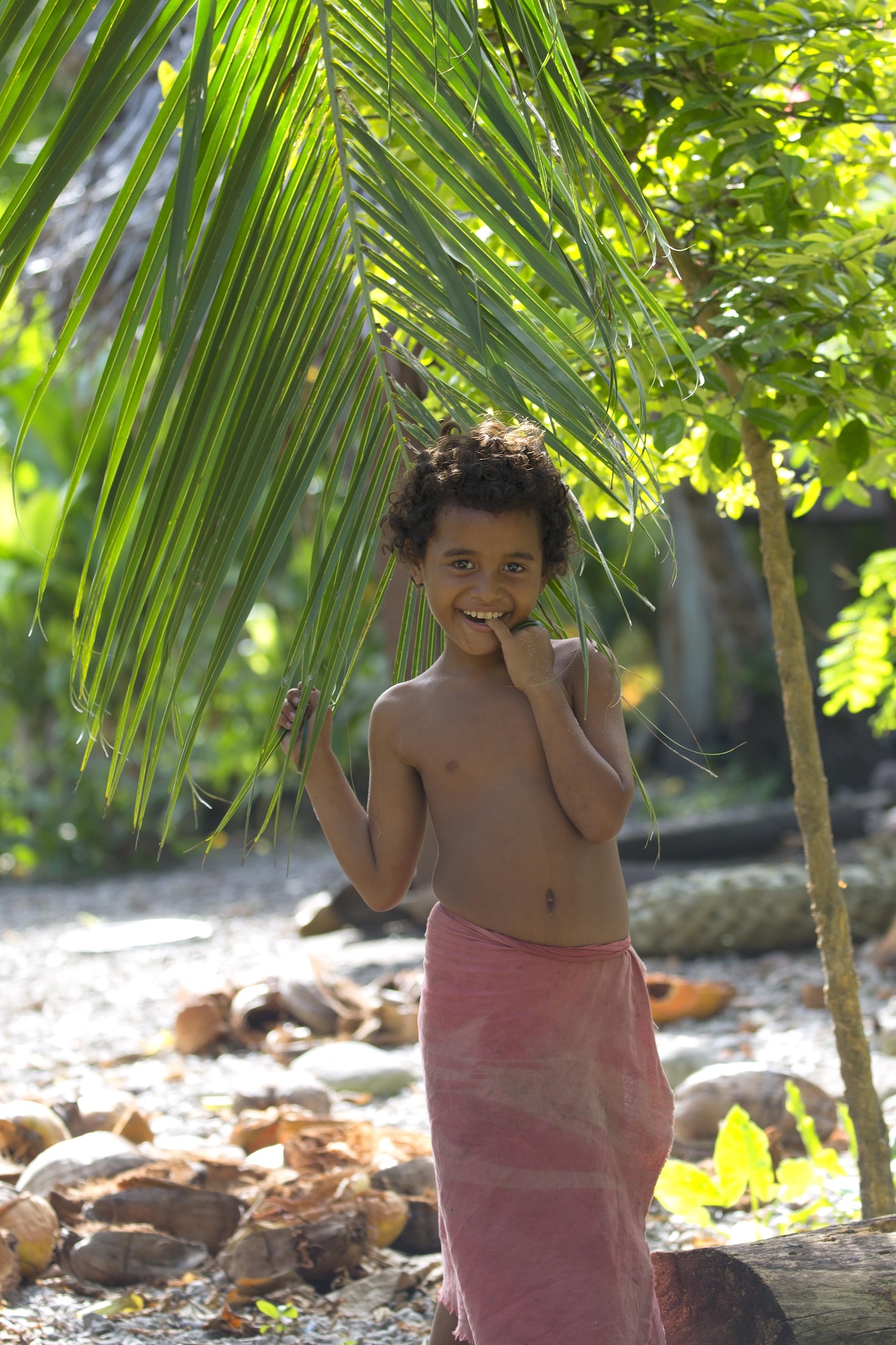 Nigh Hazong, 10, shows his smile under a coconut tree at Fais Island, Federated States of Micronesia, Dec. 8, 2015 during Operation Christmas Drop 2015. Fais Island is a raised coral island in the eastern Caroline Islands in the Pacific Ocean, and forms a legislative district in Yap State in the FSM. Fais Island is located approximately 54 miles east of Ulithi Atoll and 156 miles northeast of Yap. This year marks the first trilateral execution that includes air support from the Japan Air-Self Defense force and the Royal Australian Air Force. (U.S. Air Force photo by Osakabe Yasuo/Released)
