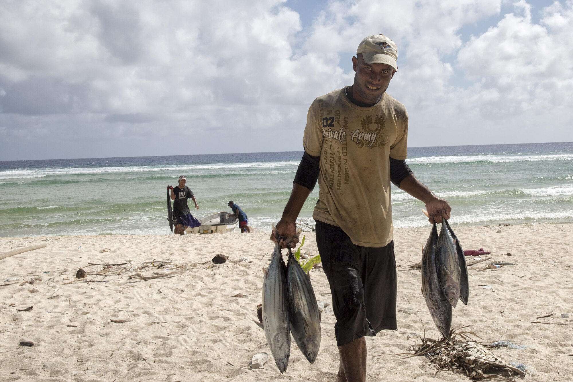 A fisherman carries tunas to a man's house at Fais Island, Federated States of Micronesia, Dec. 8, 2015. In Fais, there are three villages and one head chief who is Louis Mangtau, he divides harvests evenly. No one can  touch it until he’s finished. After that each village then takes its harvests to distribute among the families evenly. (U.S. Air Force photo by Osakabe Yasuo/Released)