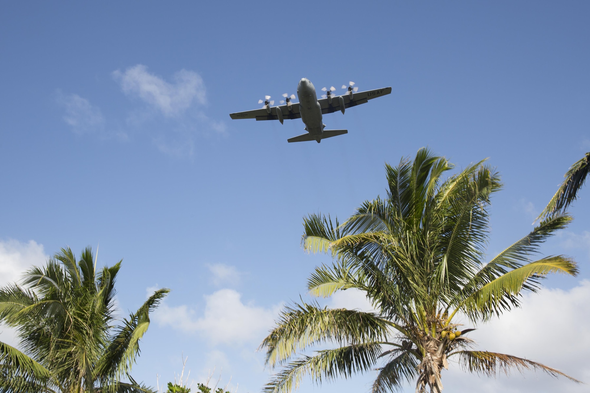 A C-130 Hercules assigned to the 36th Airlift Squadron drops a bundles during Operation Christmas Drop 2015, at Fais island, Federated States of Micronesia, Dec. 8, 2015. Airmen delivered over 800 pounds of supplies to the island of Fais during Operation Christmas Drop 2015. This year marks the first trilateral Operation Christmas Drop where the U.S. Air Force, Japan Air Self-Defense Force and the Royal Australian Air Force work together to provide critical supplies to 56 Micronesian islands. (U.S. Air Force photo by Osakabe Yasuo/Released)