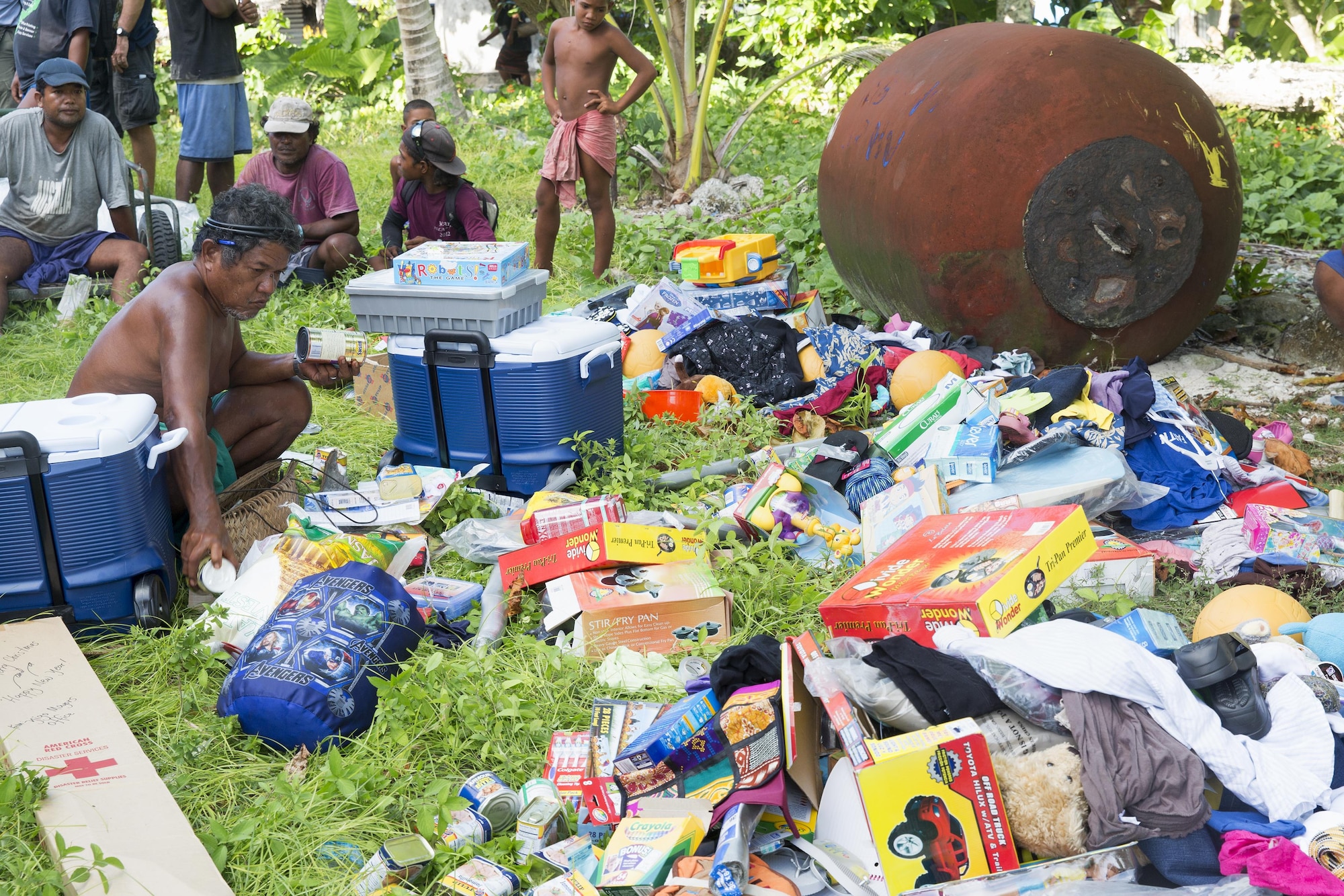 Louis Mangtau, Chief of Fais Island, sorts through supplies that were dropped during Operation Christmas Drop 2015, Dec. 8, 2015, at Fais Island, Federated States of Micronesia. Operation Christmas Drop is a humanitarian/disaster relief training event where C-130 crews provide critical supplies to 56 islands throughout the Commonwealth of the Northern Marianas, Federated States of Micronesia and Republic of Palau. This year marks the first ever trilateral execution that includes air support from the U.S. Air Force, Japan Air Self-Defense Force and the Royal Australian Air Force. (U.S. Air Force photo by Osakabe Yasuo/Released)