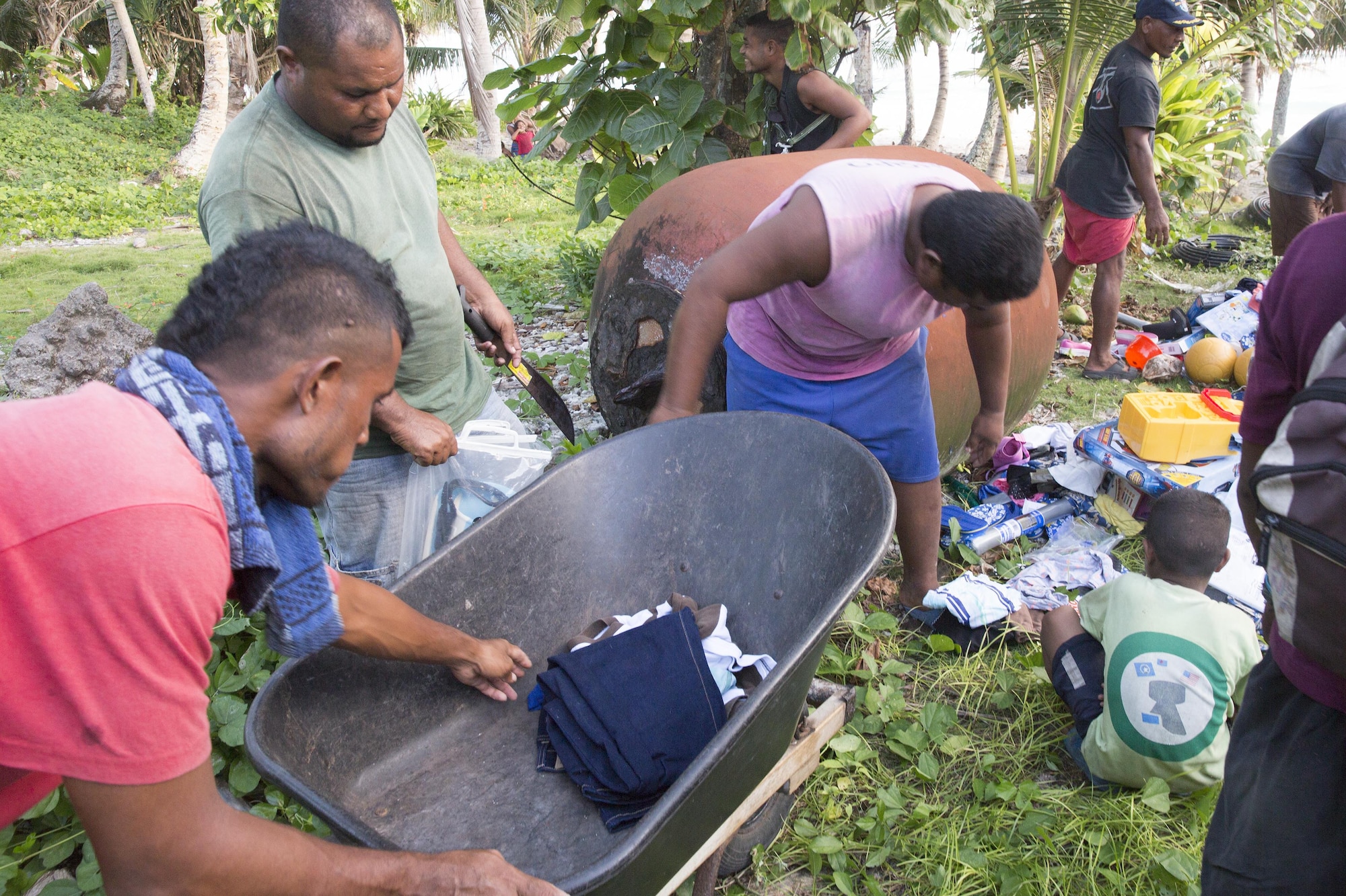 Villages load and sort the donated supplies that were dropped during Operation Christmas Drop 2015, Dec. 8, 2015, at Fais Island, Federated States of Micronesia. Operation Christmas Drop is a humanitarian/disaster relief training event where C-130 crews provide critical supplies to 56 islands throughout the Commonwealth of the Northern Marianas, Federated States of Micronesia and Republic of Palau. This year marks the first ever trilateral execution that includes air support from the U.S. Air Force, Japan Air Self-Defense Force and the Royal Australian Air Force. (U.S. Air Force photo by Osakabe Yasuo/Released)