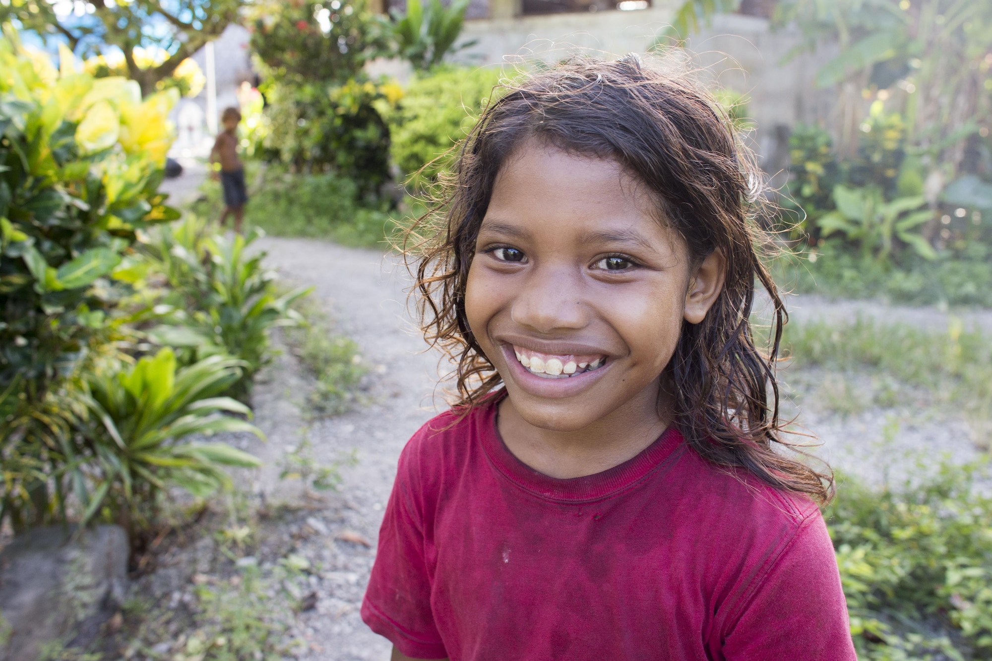 A island child smiles in anticipation of gifts during Operation Christmas Drop at Fais Island, Federated States of Micronesia, Dec. 8, 2015. A C-130 Hercules from the 36th Airlift Squadron delivered more than 800 pounds of supplies to Fais island during Operation Christmas Drop 2015. This year marks the first trilateral execution that includes air support from the Japan Air-Self Defense Force and the Royal Australian Air Force. (U.S. Air Force photo by Osakabe Yasuo/Released)