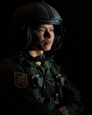 Japan Air Self-Defense Force Capt. Yusaku Kariya, 401st Squadron C-130 pilot, waits to drop a bundle over Pacific Ocean during Operation Christmas Drop, Dec. 9, 2105. This year marks the first time allied partners from JASDF and Royal Australian Air Force joined the U.S. in the humanitarian aid/disaster relief training event. During the training missions, C-130 aircrews perform low-cost low-altitude airdrops on unsurveyed drop zones while providing critical supplies to 56 islands throughout the Commonwealth of the Northern Marianas, Federated States of Micronesia and Republic of Palau. It highlights the U.S. and allied airpower capabilities to orient and respond to activities in peacetime and crisis. In addition to delivering critical supplies to those in need, Operation Christmas Drop provides specific training to U.S. and allied aircrews, enabling theater-wide airpower. (U.S. Air Force photo by Osakabe Yasuo/Released)