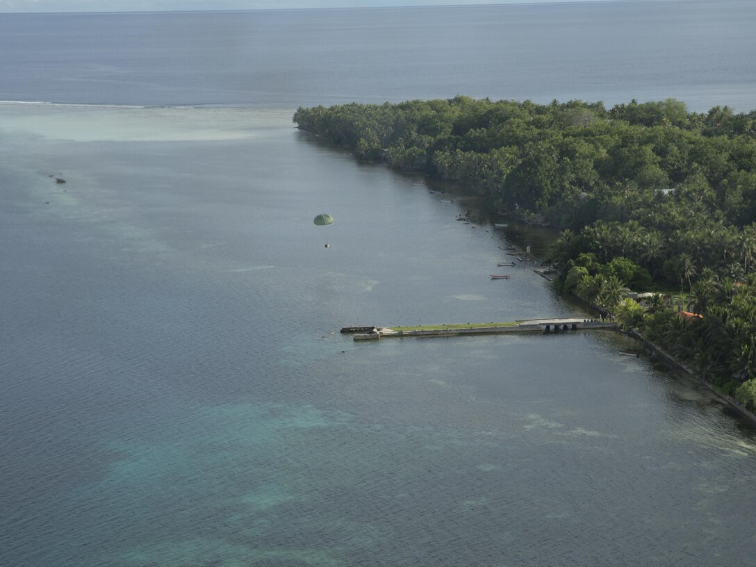 A low-cost low-altitude bundle of donated goods drops to Lukunor Atoll, Federated States of Micronesia, Dec. 9, 2015, during Operation Christmas Drop. This year marks the 64th year of Operation Christmas Drop, which began in 1952, making it the world's longest-running airdrop mission. This is the first ever trilateral training event that includes additional air support from Japan Air Self-Defense Force and Royal Australian Air Force C-130 aircrews. (U.S. Air Force photo by Osakabe Yasuo/Released)