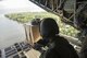 Airmen from the Japan Air Self-Defense Force and U.S. Air Force push a low-cost, low-altitude bundle over Lukunor Atoll, Federated States of Micronesia, Dec. 9, 2015, during Operation Christmas Drop. This year marks the 64th year of Operation Christmas Drop, which began in 1952, making it the world's longest-running airdrop mission. This is the first ever trilateral training event that includes additional air support from JASDF and Royal Australian Air Force C-130 aircrews. (U.S. Air Force photo by Osakabe Yasuo/Released)