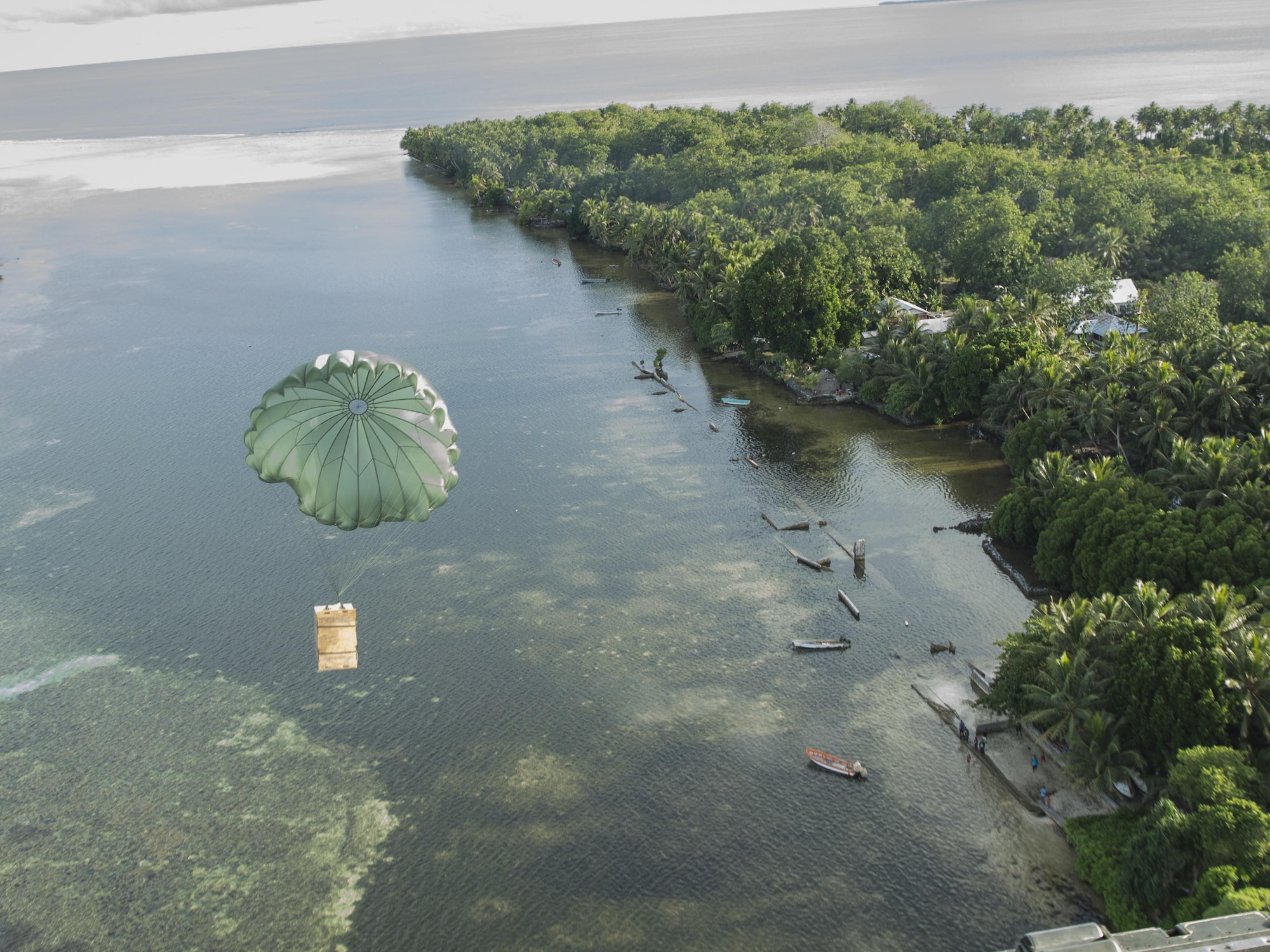 A low-cost low-altitude bundle of donated goods drops to Lukunor Atoll, Federated States of Micronesia, Dec. 9, 2015, during Operation Christmas Drop. This year marks the 64th year of Operation Christmas Drop, which began in 1952, making it the world's longest-running airdrop mission. This is the first ever trilateral training event that includes additional air support from Japan Air Self-Defense Force and Royal Australian Air Force C-130 aircrews. (U.S. Air Force photo by Osakabe Yasuo/Released)