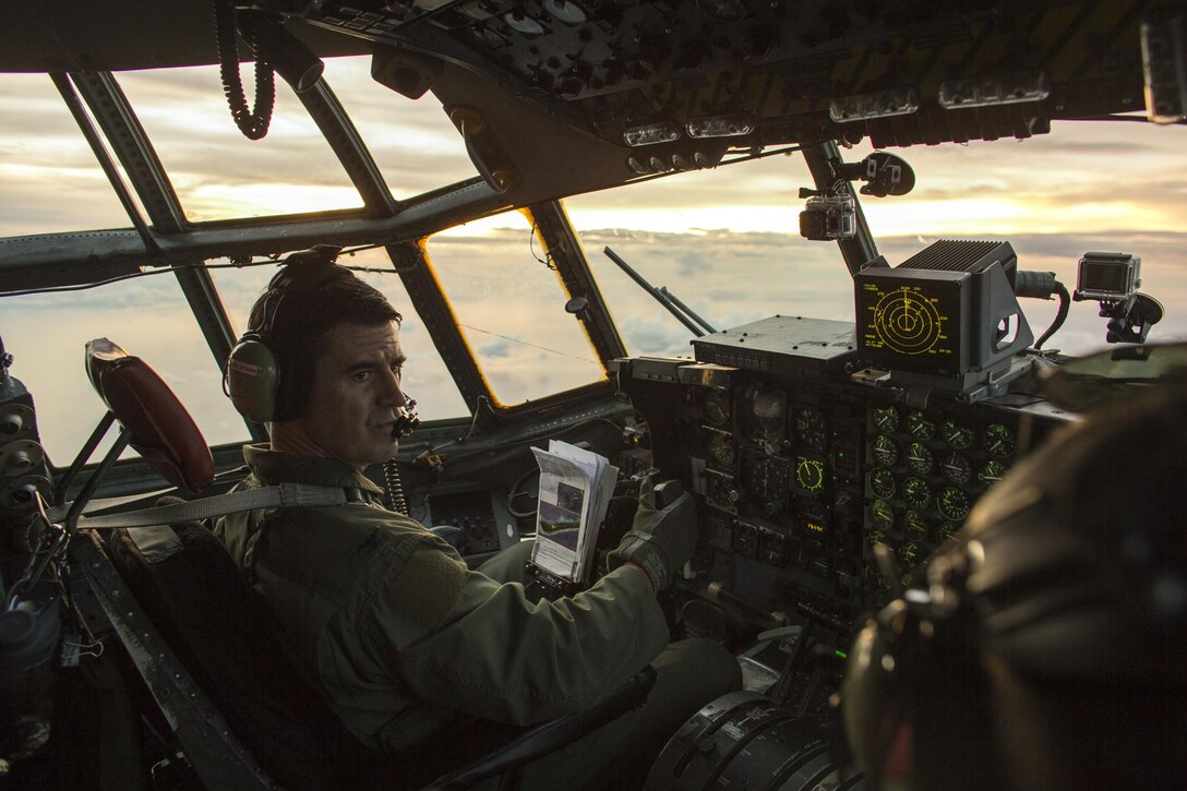 Col. Robert Dotson, 374th Operation Group commander, flies over the Pacific Ocean, Dec. 9, 2015, during Operation Christmas Drop. Every December, C-130H Hercules aircrews from Yokota head to Andersen Air Force Base to execute low-cost, low-altitude humanitarian airdrops to islanders throughout the Commonwealth of the Northern Marianas, Federated States of Micronesia, Republic of Palau. These islands are some of the most remote locations on the globe spanning a distance nearly as broad as the continental U.S. It is the longest-running Department of Defense humanitarian airdrop operation with 2015 being the first trilateral execution with support from Japan Air Self-Defense Force and Royal Australian Air Force. (U.S. Air Force photo by Osakabe Yasuo/Released)