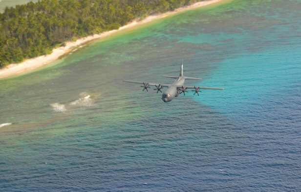 A Royal Australian Air Force C-130J flies over the Federated States of Micronesia during Operation Christmas Drop, Dec. 8, 2015. The RAAF dropped the first official bundle to the island of MogMog during the first trilateral execution of the training mission alongside Japanese Air Self-Defense Force and U.S. Air Force. Operation Christmas Drop is a humanitarian aid/disaster relief training event where C-130 crews provide critical supplies to 56 islands throughout the Commonwealth of the Northern Marianas, Federated States of  Micronesia and Republic of Palau. (U.S. Air Force photo by Tech. Sgt. Melissa K. Mekpongsatorn)