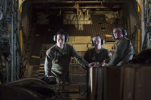 (Left to right) Lt. Col. Andrew Campbell, Staff Sgt. Ren Forbes, and Airman 1st Class Alexander Lauher, 36th Airlift Squadron, check bundles before executing airdrops to Mortlock Islands in Federated States of Micronesia, Dec. 9, 2015, during Operation Christmas Drop 2015. This year marks the 64th year of Operation Christmas Drop and the first time international partners joined in execution through Japan Air Self-Defense Force and Royal Australian Air Force C-130 support. The event provides critical supplies to 56 Micronesian islands impacting about 20,000 people covering 1,000 by 1,800 nautical miles of operation area. (U.S. Air Force photo by Osakabe Yasuo/Released)