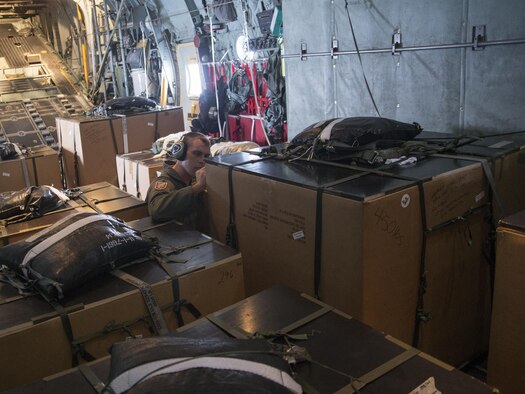 Lt. Col. Andrew Campbell, 36th Airlift Squadron commander, writes a holiday greeting to the recipients of one of the boxes packed in support of Operation Christmas Drop, Dec. 9, 2015. This year marks the first ever trilateral Operation Christmas Drop where the U.S. Air Force, Japan Air Self-Defense Force and the Royal Australian Air Force work together to provide critical supplies to 56 islands, impacting 20,000. (U.S. Air Force photo by Osakabe Yasuo/Released)