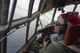 Cant. John Menezes, 36th Airlift Squadron C-130 pilot, looks down his window while flying a C-130 Hercules through islands near Ettal Atoll, Federated Sates of Micronesia, Dec. 9, 2015, during Operation Christmas Drop. This is a humanitarian aid/disaster relief training event where C-130 aircrews perform low-cost low-altitude airdrops on unsurveyed drop zones while providing critical supplies to 56 islands throughout the Commonwealth of the Northern Marianas, Federated States of Micronesia and Republic of Palau. It highlights the U.S. and allied airpower capabilities to orient and respond to activities in peacetime and crisis. In addition to delivering critical supplies to those in need, Operation Christmas Drop provides specific training to U.S. and allied aircrews, enabling theater-wide airpower. (U.S. Air Force photo by Osakabe Yasuo/Released)